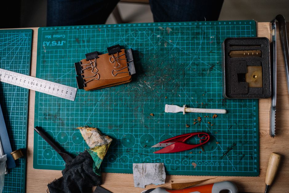 Top view of a craft workspace showcasing various tools and materials on a cutting mat.